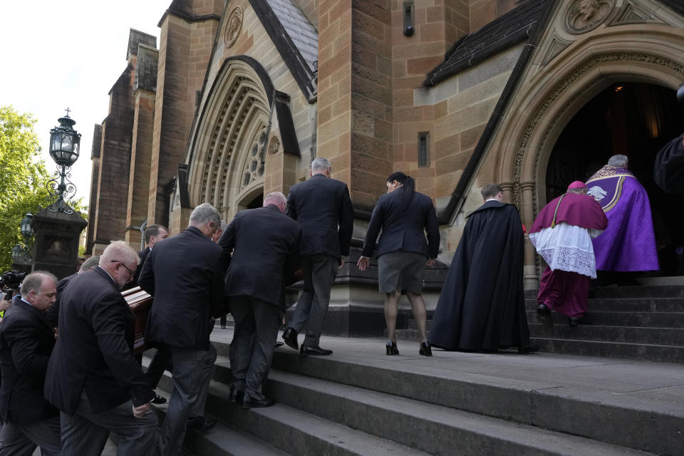 The coffin of Cardinal George Pell is carried into St. Mary's Cathedral in Sydney, Wednesday, Feb. 1, 2023. Pell, who was once considered the third-highest ranking cleric in the Vatican and spent more than a year in prison before his child abuse convictions were squashed in 2020, died in Rome last month at age 81. (AP Photo/Rick Rycroft)