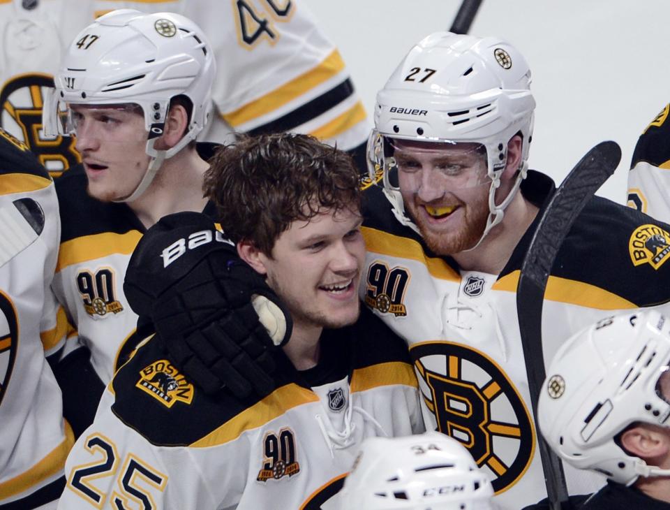 Boston Bruins' Matt Fraser (25) celebrates with teammate Dougie Hamilton after scoring the winning goal against the Montreal Canadiens during the first overtime period in Game 4 in the second round of the NHL Stanley Cup playoffs Thursday, May 8, 2014, in Montreal. (AP Photo/The Canadian Press, Ryan Remiorz)