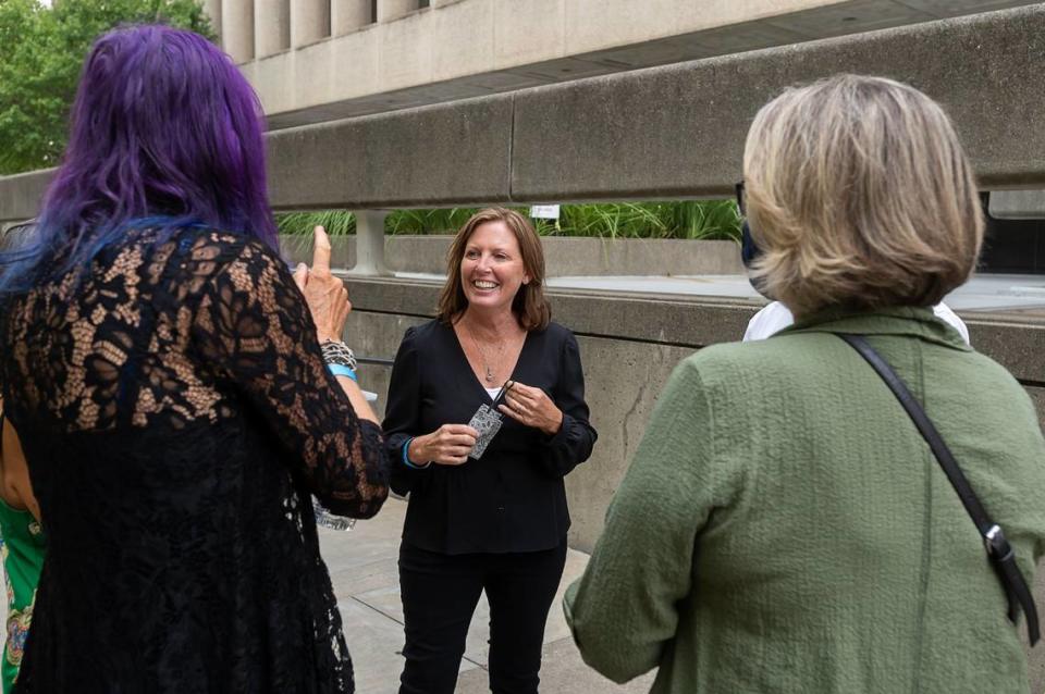 Kris Pedretti talks with other victims of the Golden State Killer after she gave her impact statement at the Sacramento County Courthouse in August 2020.