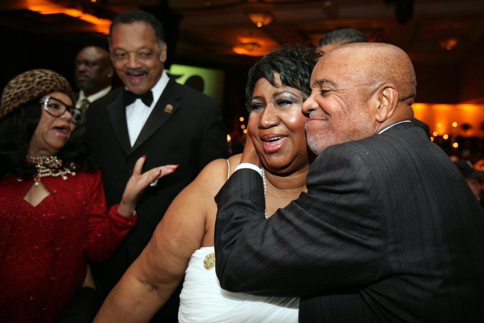 Berry Gordy hugs Aretha Franklin while Jesse Jackson and a guest looks on at the Motown 50 Golden Gala Live it Again Weekend at the Renaissance Center in Detroit on Nov. 21, 2009.