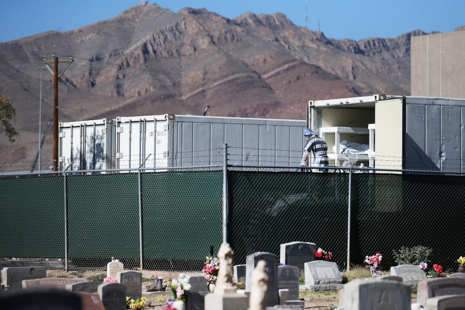 Workers prepare to load bodies wrapped in plastic into a refrigerated temporary morgue trailer in a parking lot of the El Paso County Medical Examiner's office in Texas on Nov. 16. (Photo by Mario Tama/Getty Images)