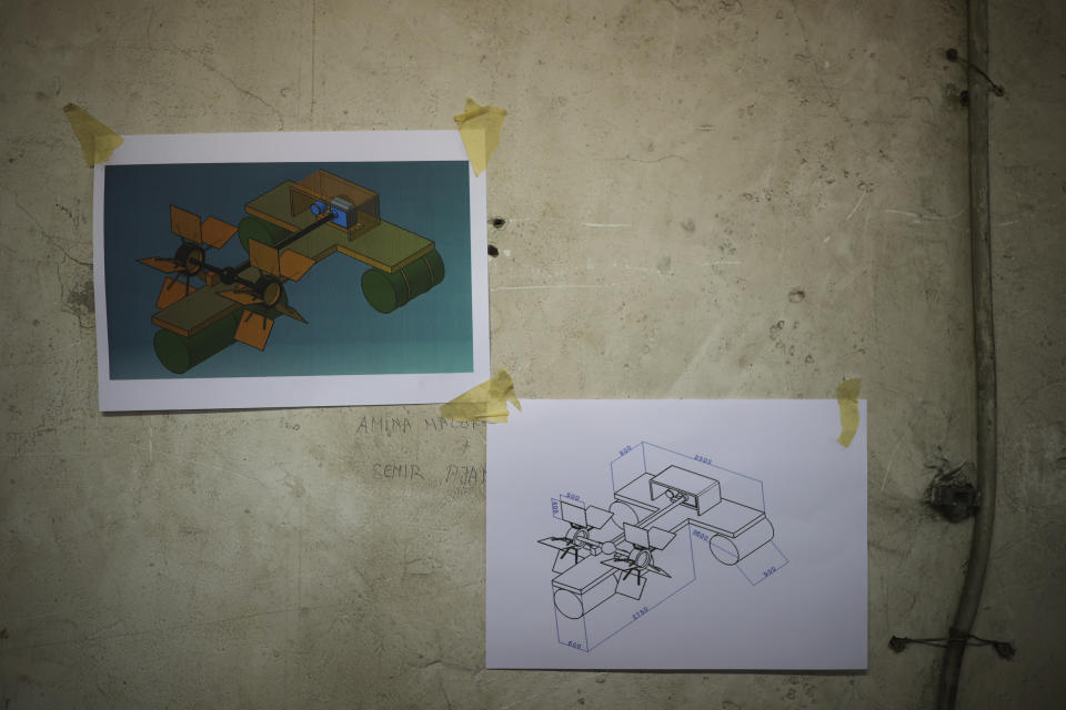 A technical drawing of an improvised hydropower plant is seen taped on a wall of a high school workshop in Gorazde, Bosnia, Monday, Dec. 19, 2022. To survive and keep the lights on in their besieged town - cut off throughout Bosnia's 1992-95 interethnic war from access to electricity grid, food, medicine and the outside world - the people of Gorazde had to come up with various creative inventions. (AP Photo/Armin Durgut)