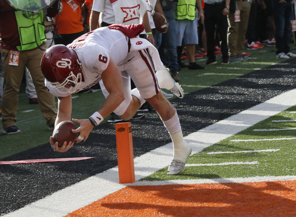 FILE - Oklahoma quarterback Baker Mayfield (6) dives into the end zone with a touchdown in the first half of an NCAA college football game against Oklahoma State in Stillwater, Okla., Nov. 4, 2017. Oklahoma and Oklahoma State will meet on Saturday for the final time before Oklahoma leaves the Big 12 for the Southeastern Conference. (AP Photo/Sue Ogrocki, File)