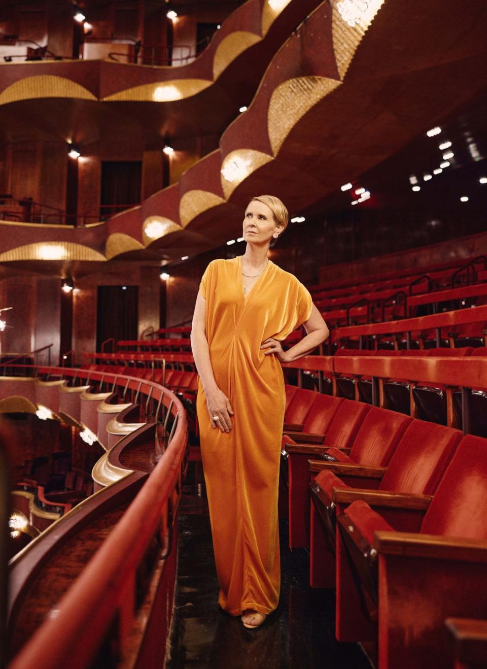 a man in a robe standing in a theater