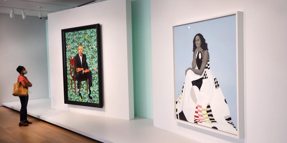 Visitors in Chicago, Illinois view the official portraits of former president Barack Obama by Kehinde Wiley and former first lady Michelle Obama by Amy Sherald at The Art Institute of Chicago on June 18, 2021.