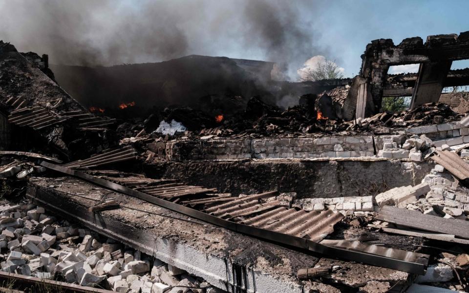 Smoke rises at a warehouse after shelling in Severodonetsk - YASUYOSHI CHIBA/AFP via Getty Images