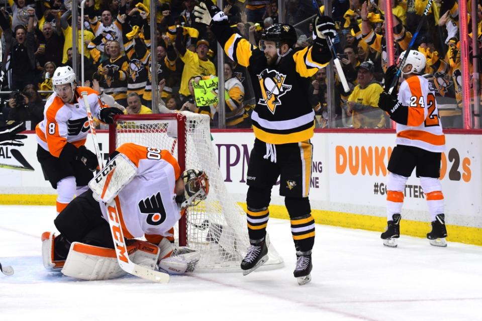 PITTSBURGH, PA – APRIL 20: Bryan Rust #17 of the Pittsburgh Penguins celebrates after scoring a goal against the <a class="link " href="https://sports.yahoo.com/nhl/teams/philadelphia/" data-i13n="sec:content-canvas;subsec:anchor_text;elm:context_link" data-ylk="slk:Philadelphia Flyers;sec:content-canvas;subsec:anchor_text;elm:context_link;itc:0">Philadelphia Flyers</a> in Game Five of the Eastern Conference First Round during the 2018 NHL Stanley Cup Playoffs at PPG PAINTS Arena on April 20, 2018 in Pittsburgh, Pennsylvania. (Photo by Matt Kincaid/Getty Images)