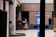 Emergency Medical Technicians (EMT) arrive with a patient to Jackson Health Center, where the coronavirus disease (COVID-19) patients are treated, in Miami