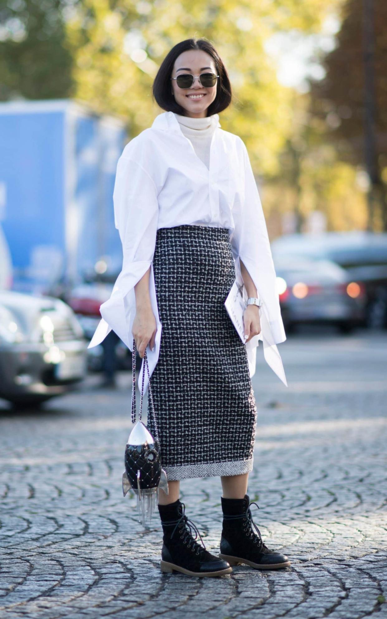 Blogger Yoyo Cao pairs a tweed pencil skirt with a crisp white shirt and lace-up boots at Paris Fashion Week  - Getty Images Europe