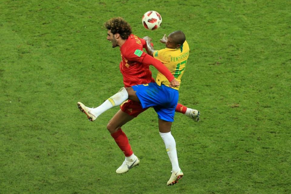 Marouane Fellaini of Belgium becomes embroiled in an on-pitch colour clash with Fernandinho of Brazil.