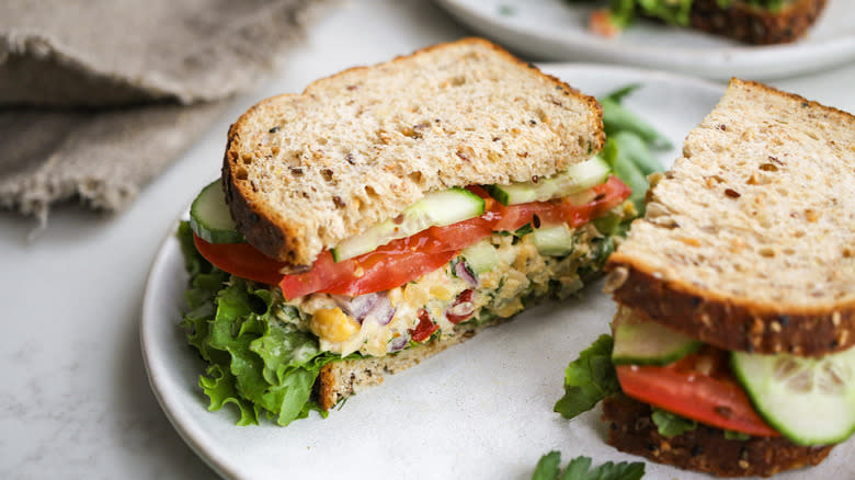 chickpea salad sandwich halves on white plate