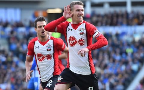 Southampton's Northern Irish midfielder Steven Davis celebrates with Southampton's German-born Portuguese defender Cedric Soares - Credit: GLYN KIRK/AFP/Getty Images