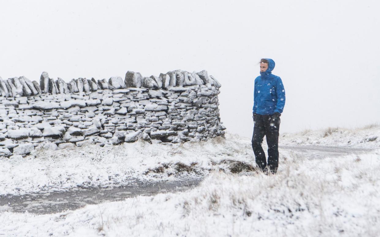 A man walks through snow yesterday in Nenthead, Cumbria - Jordan Crosby