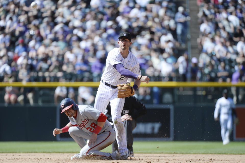 Colorado Rockies second baseman Ryan McMahon throws to first base in the sixth inning of a baseball game Sunday, April 9, 2023, in Denver. (AP Photo/Geneva Heffernan)