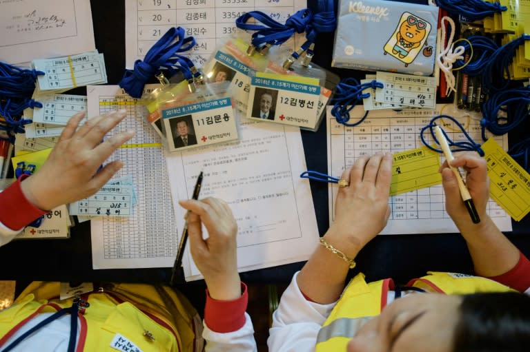 Korean Red Cross workers register participants arriving at a hotel before the reunion