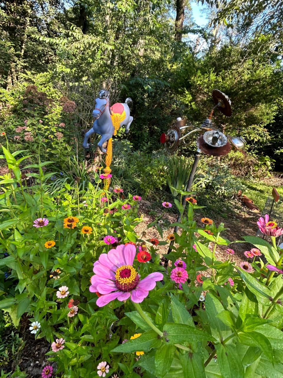 Flowers are in the foreground, sculptures in the background at Old Pine Farm. Sally Willowbee, the former owners' daughter, is now the site's caretaker.