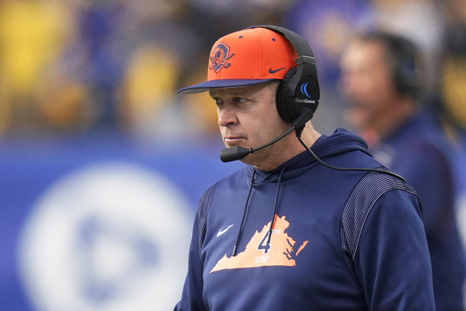 FILE - Virginia coach Bronco Mendenhall watches the team's NCAA college football game against Pittsburgh on Nov. 20, 2021, in Pittsburgh. Mendenhall is stepping down after the Cavaliers play their bowl game, abruptly ending his tenure at the school after six seasons. The surprising announcement came in a news release Thursday, Dec. 2. In a hastily organized conference call with reporters, Mendenhall said the decision was his alone and that both athletic director Carla Williams and university president Jim Ryan asked him to stay. (AP Photo/Keith Srakocic, File)