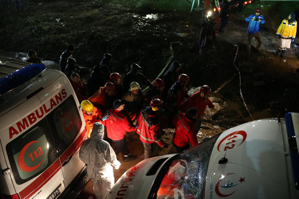 Rescue members evacuate an injured person from the wreckage of a plane after it skidded off the runway at Istanbul's Sabiha Gokcen Airport, in Istanbul, Wednesday, Feb. 5, 2020. The plane skidded off as it tried to land in bad weather, crashing into a field and breaking into pieces. Passengers had to evacuate through cracks in the smashed plane and authorities said 120 people were sent to the hospital with injuries. (AP Photo/Emrah Gurel)