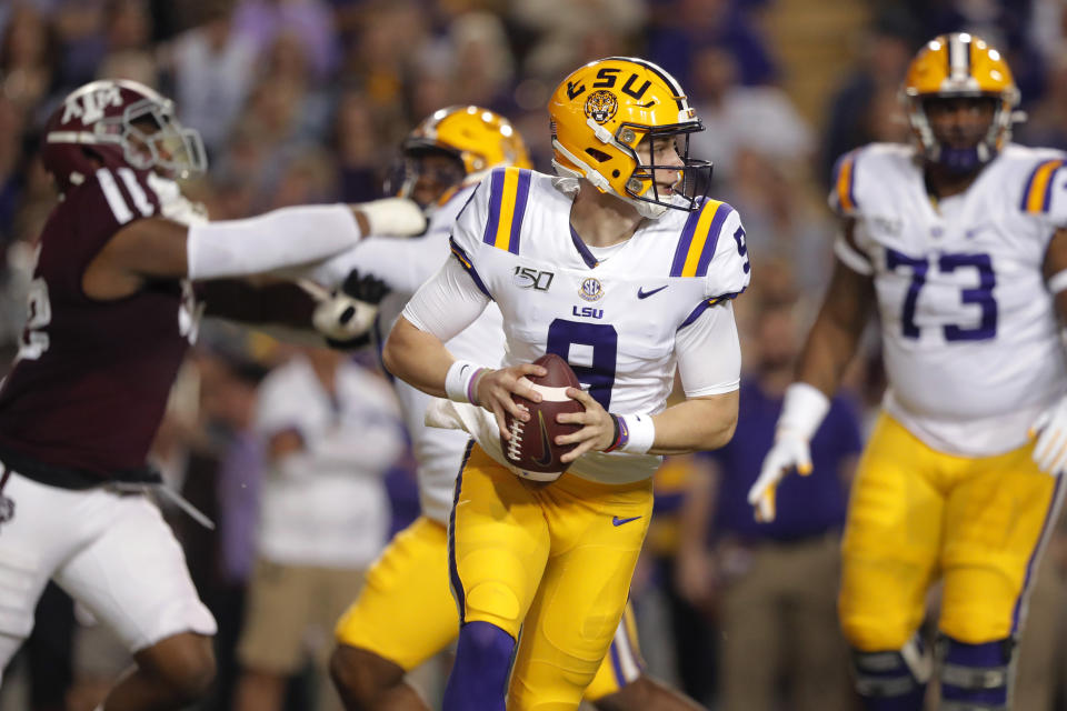 LSU quarterback Joe Burrow (9) looks for a receiver during the first half of the team's NCAA college football game against Texas A&M in Baton Rouge, La., Saturday, Nov. 30, 2019. (AP Photo/Gerald Herbert)