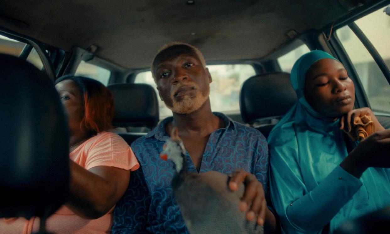 <span>A still from the film Nyame Mma (Children of God). The lead character, Kwamena, played by Kobina Amissah-Sam sits centre.</span><span>Photograph: Nyame Mma</span>