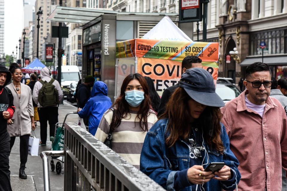 People walk past a COVID mobile testing facility at Times Square in Manhattan, May 2, 2022. The White House is stepping up its warnings about a coronavirus surge this fall and winter and is making contingency plans for how it will provide vaccines to the American public if Congress does not allocate more money for the response, according to a senior administration official. (Stephanie Keith/The New York Times)