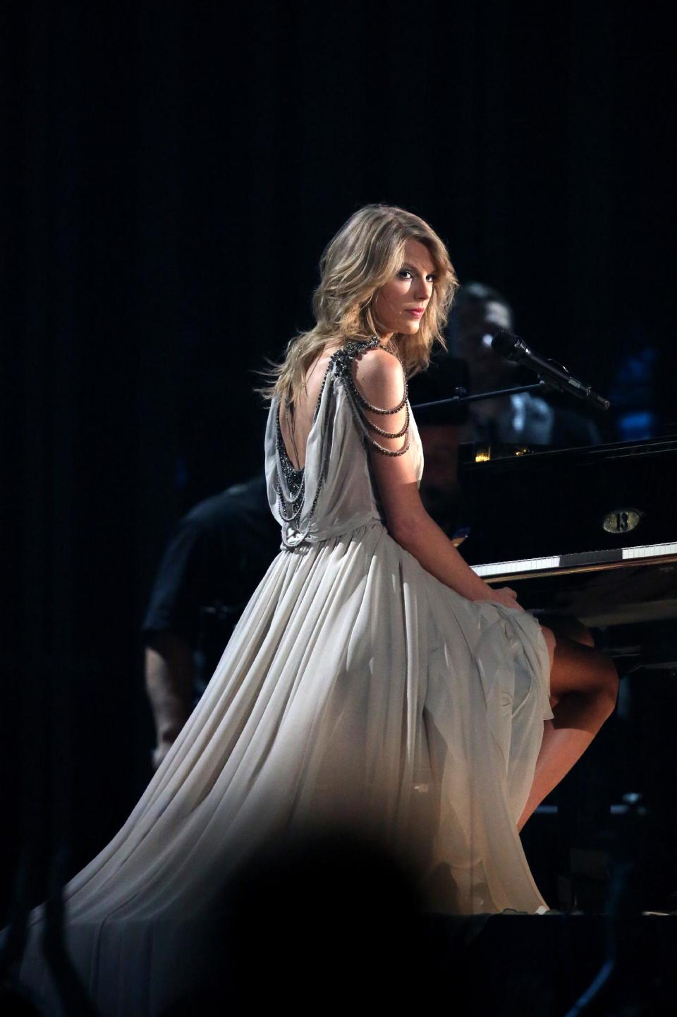 FILE - In this Jan. 26, 2014 file photo, Taylor Swift performs "All of Me" at the 56th annual Grammy Awards at Staples Center in Los Angeles. Swift has had a relationship with the "Now That's What I Call Music" series for more than a decade. The series has reached No. 50, a serious milestone for a physical sales survivor that's managed to navigate all the changes in our digital world to remain relevant, profitable and incredibly consistent since its U.S. debut 16 years ago. (Photo by Matt Sayles/Invision/AP, file)