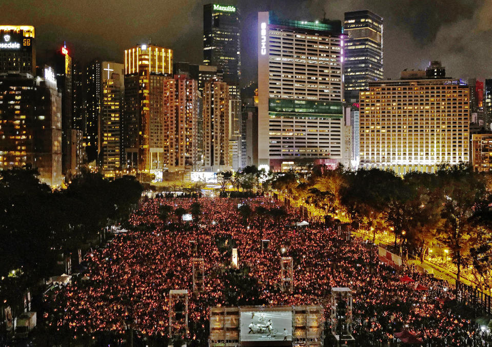 FILE-In this Tuesday, June 4, 2019, file photo, thousands of people attend a candlelight vigil for victims of the Chinese government's brutal military crackdown three decades ago on protesters in Beijing's Tiananmen Square at Victoria Park in Hong Kong. Hong Kong authorities for the second year have banned the June 4 candlelight vigil to commemorate the bloody crackdown on pro-democracy protests in Beijing's Tiananmen Square, organizers said Thursday, May 27, 2021. (AP Photo/Vincent Yu, File)