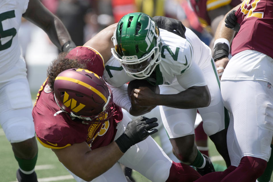 New York Jets quarterback Tyrod Taylor (2) is sacked by Washington Commanders defensive tackle Benning Potoa'e during the first half of an NFL preseason football game Saturday, Aug. 10, 2024, in East Rutherford. N.J. (AP Photo/Pamela Smith)