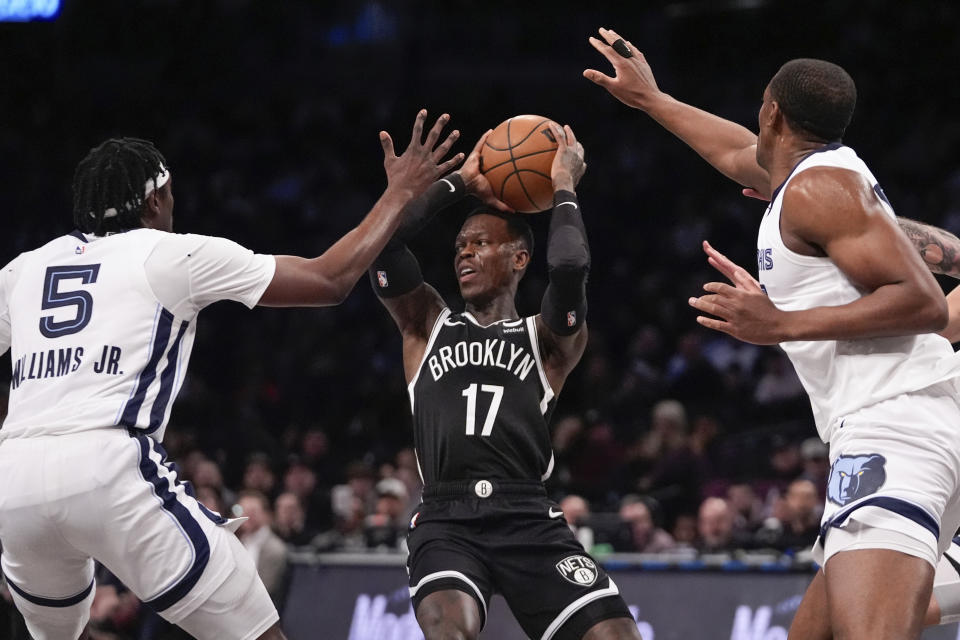 Brooklyn Nets' Dennis Schroder (17) passes away from Memphis Grizzlies' Vince Williams Jr. (5) and Trey Jemison during the first half of an NBA basketball game, Monday, March 4, 2024, in New York. (AP Photo/Frank Franklin II)