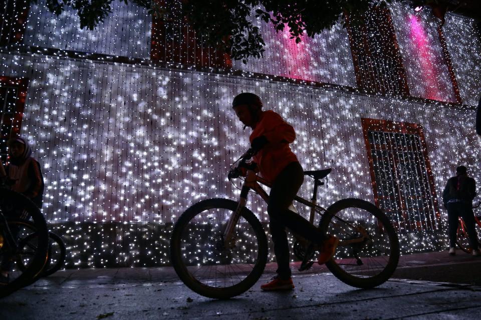 Thousands of bikers take to the streets during an annual event called ‘Ciclovia Nocturna’ in Bogotá, Colombia. <a href="https://www.gettyimages.com/detail/news-photo/thousands-of-people-took-to-the-streets-on-their-bicycles-news-photo/1237135190?adppopup=true" rel="nofollow noopener" target="_blank" data-ylk="slk:Juan David Moreno Gallego/Anadolu Agency via Getty Images;elm:context_link;itc:0;sec:content-canvas" class="link ">Juan David Moreno Gallego/Anadolu Agency via Getty Images</a>