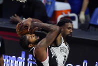 Los Angeles Clippers guard Paul George, left, is fouled by Brooklyn Nets center DeAndre Jordan during the second half of an NBA basketball game Sunday, Feb. 21, 2021, in Los Angeles. (AP Photo/Mark J. Terrill)