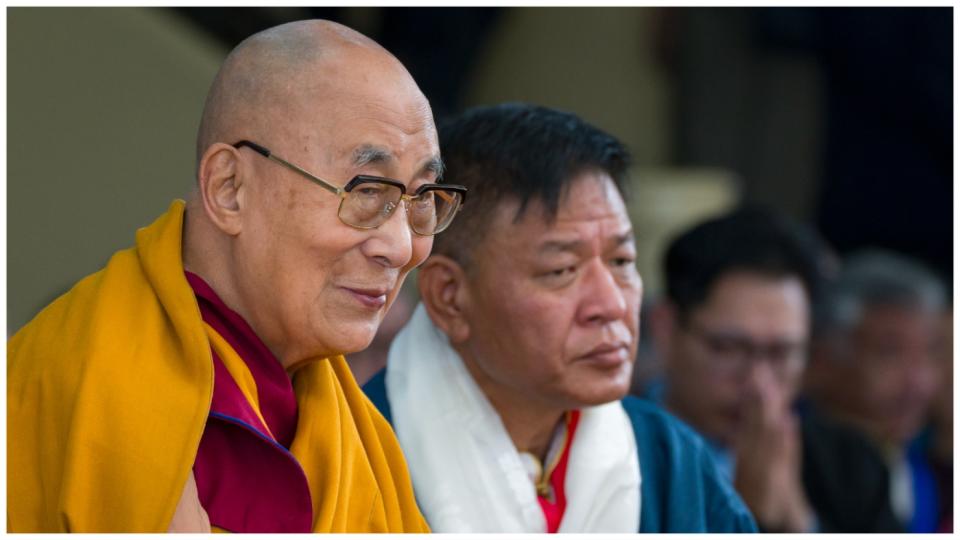 Tibetan spiritual leader the Dalai Lama smiles as he sits next to Penpa Tsering, the president of the Central Tibetan Administration, during a function marking his 88th birthday at the Tsuglakhang temple in Dharamshala, India, July 6, 2023.