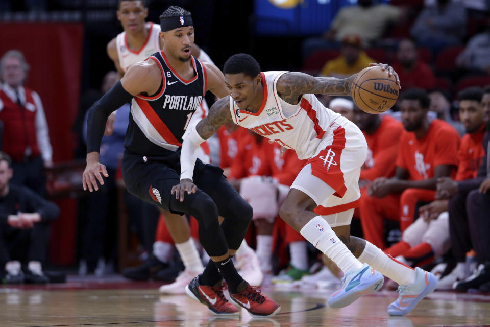 Houston Rockets guard Kevin Porter Jr., right, drives into Portland Trail Blazers guard Josh Hart, left, during the first half of an NBA basketball game Saturday, Dec. 17, 2022, in Houston. (AP Photo/Michael Wyke)