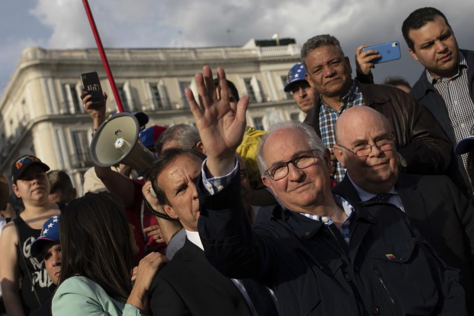 Antonio Ledezma, former mayor of Caracas, waves to supporters of Venezuelan opposition leader Juan Guaido during a gathering in Madrid, Spain, Tuesday, April 30, 2019. Thousands of Venezuelans have migrated to Spain in recent years or are seeking asylum in the country, including prominent members of the opposition and former officials who worked closely with late Venezuelan President Hugo Chavez. More than 177,000 Spaniards live in Venezuela. (AP Photo/Bernat Armangue)