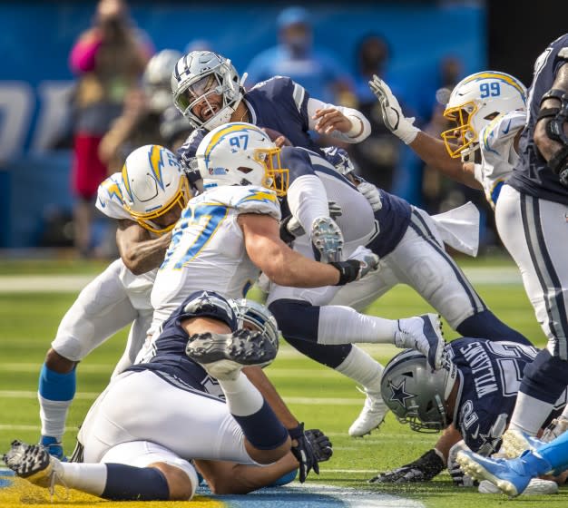 Los Angeles, CA - September 19: Los Angeles Chargers safety Derwin James Jr. left, and Joey Bosa, center, sacks Dallas Cowboys quarterback Dan Prescott in the second half at SoFi Stadium on Sunday, Sept. 19, 2021 in Los Angeles, CA. (Allen J. Schaben / Los Angeles Times)