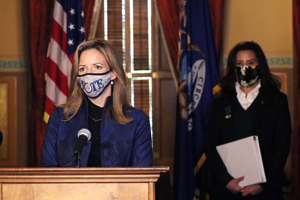 FILE - In this Wednesday, Oct. 28, 2020 photo provided by the Michigan Office of the Governor, Michigan Secretary of State Jocelyn Benson addresses the state in Lansing, Mich., accompanied by Gov. Gretchen Whitmer. In an interview with The Associated Press, Benson says politicians lying about fraud in the 2020 presidential election, Republican efforts to make voting more difficult and the continued spread of disinformation leave her deeply concerned about the future of American democracy. (Michigan Office of the Governor via AP, file)