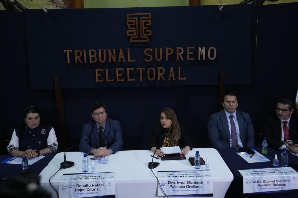 Supreme Electoral Tribunal's president Irma Palencia, center, speaks during a press conference in Guatemala City, Monday, Aug. 28, 2023. The Central American country´s top electoral tribunal declared progressive Bernardo Arevalo the winner of the presidential elections just hours after another part of the government suspended his Seed Movement party. (AP Photo/Moisés Castillo)