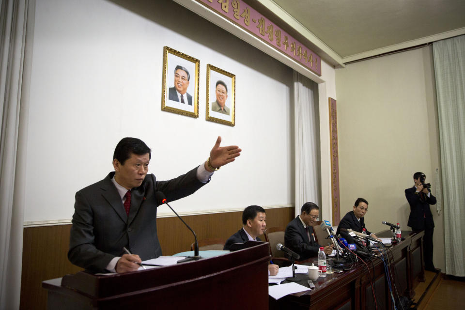 A North Korean Embassy official gestures to allow questions at a press conference by North Korean Ambassador to China Ji Jae Ryong, seated center, at the North Korean Embassy in Beijing, China, Wednesday, Jan. 29, 2014. North Korea’s propaganda machine is churning out near-daily diatribes against the United States and South Korea for a series of soon-to-start military maneuvers, warning nuclear war could be imminent and saying it will take dramatic action of its own if further provoked. Ji offered a somewhat less caustic line at a rare news conference on Wednesday. Ji told international media the north wanted to reduce tensions to allow steps toward reconciliation and eventual unification between North and South. Also in the photo are two translators and a North Korean photographer. (AP Photo/Alexander F. Yuan)