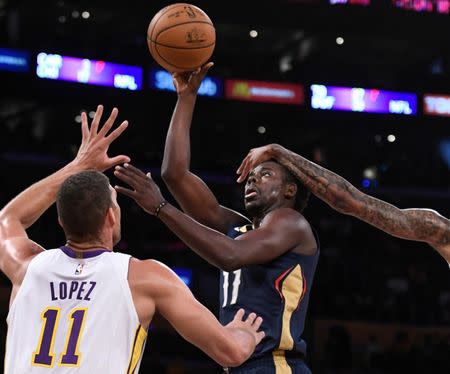 New Orleans Pelicans guard Jrue Holiday (11) puts up a shot past Los Angeles Lakers forward Brandon Ingram (1right) in front of Lakers center Brook Lopez. Robert Hanashiro-USA TODAY Sports