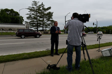 A reporter talks about the release of Chelsea Manning outside of U.S. Army base Fort Leavenworth, in Leavenworth Kansas, U.S. May 17, 2017. REUTERS/Nick Oxford