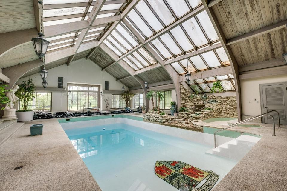 The indoor heated pool has a diving board.