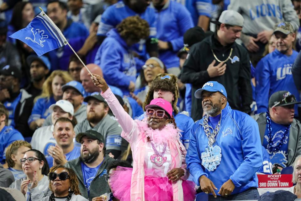 Detroit Lions fans celebrate a play against Carolina Panthers during the first half at Ford Field in Detroit on Sunday, Oct. 8, 2023.