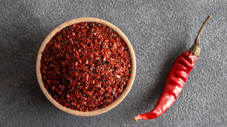 chili flakes in wooden bowl