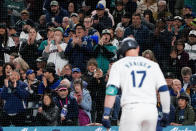 Seattle Mariners' Mitch Haniger gets a standing ovation from fans as he approaches the plate to bat against the Boston Red Sox during the second inning of an opening-day baseball game Thursday, March 28, 2024, in Seattle. (AP Photo/Lindsey Wasson)