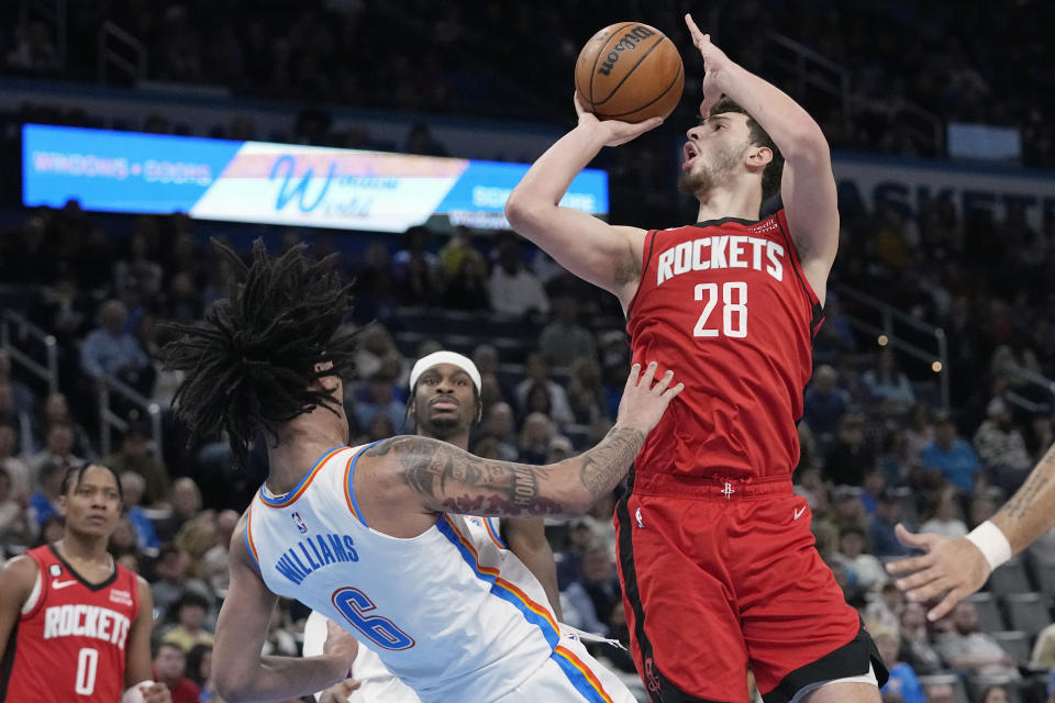 Houston Rockets center Alperen Sengun (28) fouls Oklahoma City Thunder forward Jaylin Williams (6) in the first half of an NBA basketball game Saturday, Feb. 4, 2023, in Oklahoma City. (AP Photo/Sue Ogrocki)