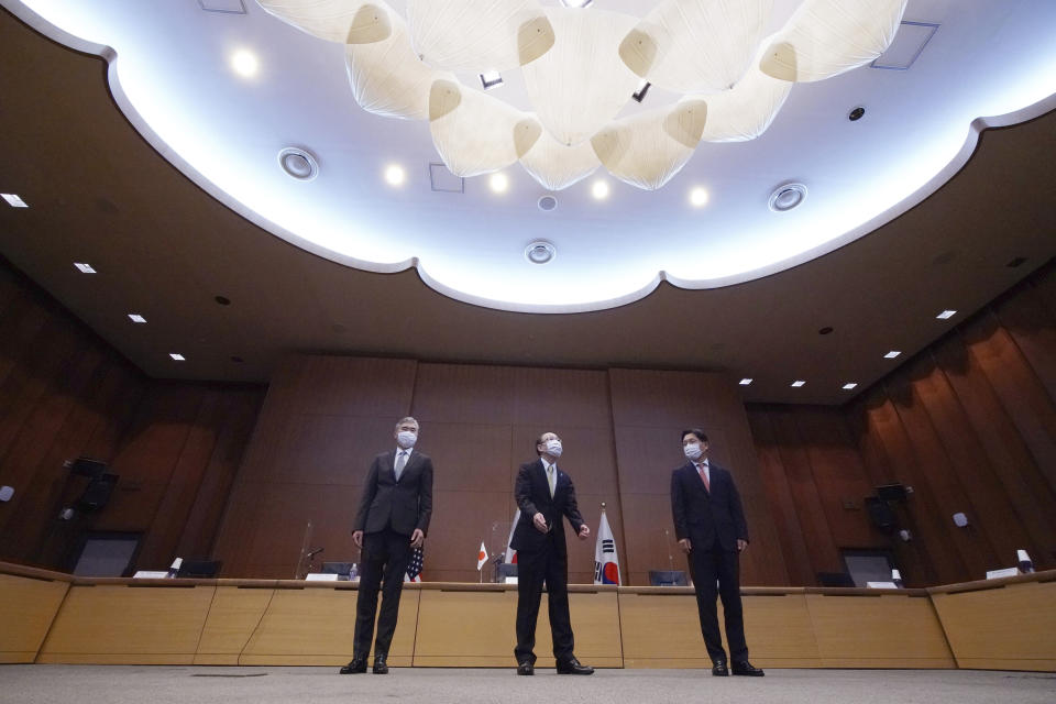 Japanese Foreign Ministry's Director-General of the Asian and Oceanian Affairs Bureau Takehiro Funakoshi, center, U.S. Special Representative for North Korea, Sung Kim, left, and South Korea's Special Representative for Korean Peninsula Peace and Security Affairs Noh Kyu-duk prepare to attend their trilateral meeting on North Korea's issues at Foreign Ministry Tuesday, Sept. 14, 2021 n Tokyo. (AP Photo/Eugene Hoshiko)