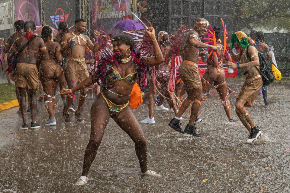 Performers dance in the rain during Miami Carnival at the Miami-Dade County Fair Expo in Miami, Florida on Sunday, October 9, 2022.