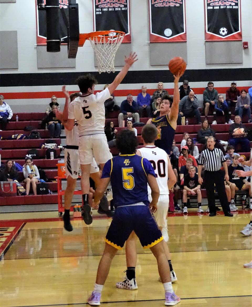Bloom-Carroll's Evan Dozer takes a shot over Fairfield Union's Ted Harrah during the Bulldogs' 52-32 Mid-State League-Buckeye Division win Tuesday night.