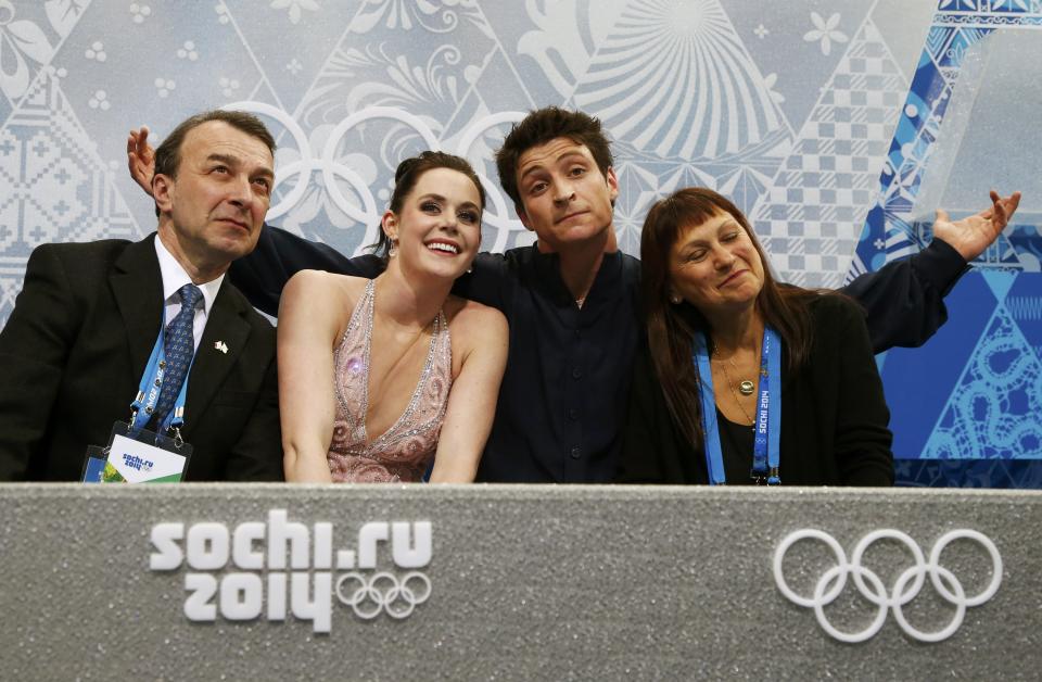 Canada's Tessa Virtue and Scott Moir react during the Figure Skating Ice Dance Free Dance Program at the Sochi 2014 Winter Olympics