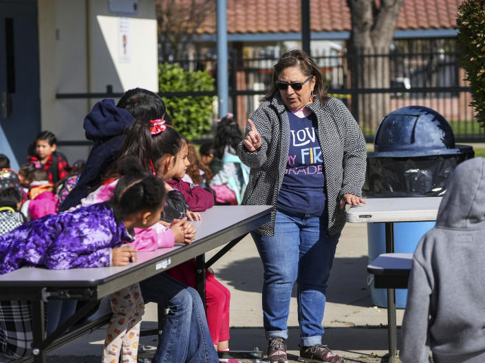 A teacher holds class on a playground at Planada Elementary School because classrooms in the building were flooded, in Planada, Calif. on Feb. 14, 2023. (Jim Wilson/The New York Times)